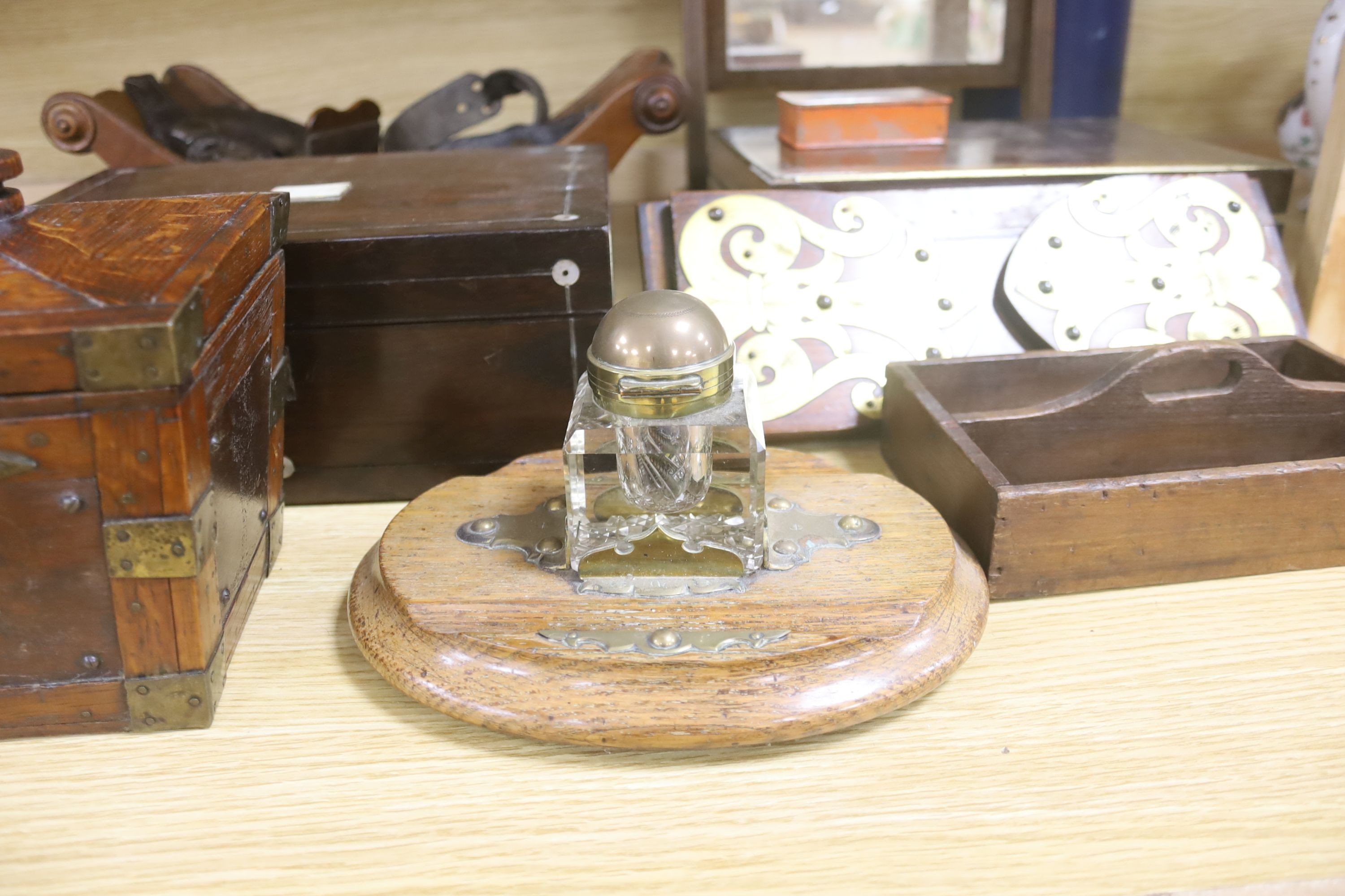 A Victorian mahogany cheese coaster, 40cm, an early 19th century toilet mirror, 29cm, an oak tea caddy, a book slide, an ink stand and sundry boxes